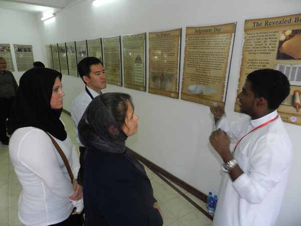 Tour group being taken around the posters by guide Nusky Naeem